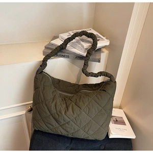 Detailed view of olive green quilted hobo bag featuring stylish ruched shoulder strap