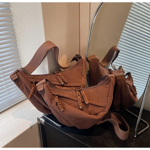 Detailed comparison of brown crescent crossbody bags in standard and mini sizes