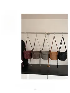 Detail showing five crossbody bags in burgundy, coffee, grey, tan and black leather