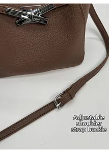 Detail of caramel lychee grain leather strap with adjustable silver buckle and fine edge oiling