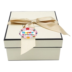 Cream square gift box with black trim, champagne ribbon, and Happy Birthday sticker