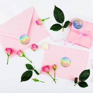 Holographic round thank you stickers for business packaging on pink gift boxes
