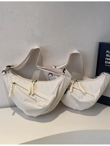 Minimalist beige nylon crescent crossbody bag in large and small sizes with adjustable straps