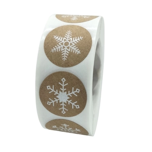 Roll of brown kraft paper Christmas stickers with white snowflakes for gift packaging