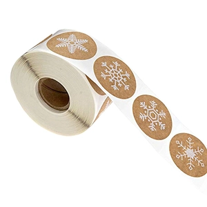 Roll of brown kraft paper Christmas stickers featuring white snowflake designs for gifts
