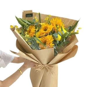 Sunflower bouquet wrapped in white and brown kraft paper roll for gift packaging