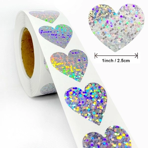Roll of 1-inch silver holographic heart stickers with sparkling rainbow laser finish