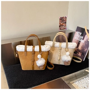 Detail of plush faux fur trim and suede texture on large capacity bucket tote bags