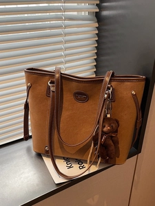 Brown suede tote bag with leather handles, drawstring sides and cute bear charm