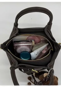 Top view of brown matte leather handbag showing large interior capacity for daily essentials