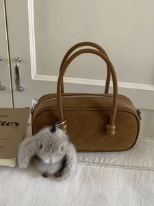 Brown suede-texture pillow handbag with wooden bead details and grey plush bunny charm