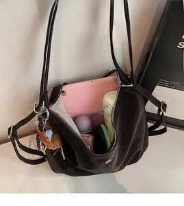 Interior view of brown soft leather tote bag showing large capacity for tablet and bottle