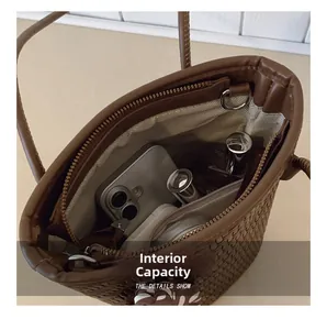 Internal capacity detail of woven bucket bag showing space for phone and cosmetics