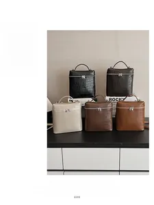 Collection of five croc-embossed vegan leather handbags in various rich colors