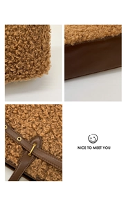 Detail view of brown faux shearling fabric and dark leather base with gold eyelets