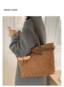 Close-up of brown teddy fur tote bag with leather straps and cookie charm detail