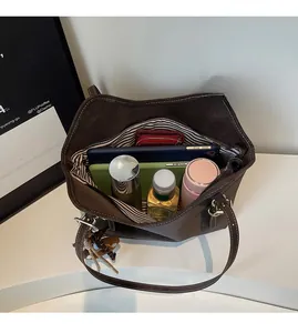 Interior view of spacious dark brown tote bag with striped lining and daily essentials