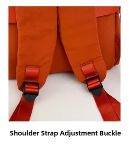 Detail of adjustable padded shoulder straps and plastic buckles on orange backpack