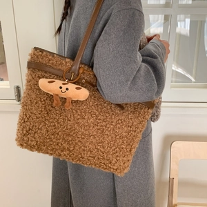 Detail of brown teddy fleece tote bag with leather straps and cute toast plush charm