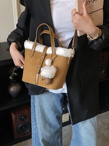 Retro faux fur bucket bag in brown suede with plush trim and adjustable shoulder strap