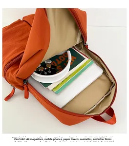 Interior view of large orange nylon backpack showing spacious main compartment and lining