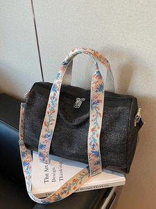 Black canvas boston handbag with colorful floral embroidery straps and top handles