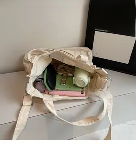 Detail view of large capacity off-white canvas tote bag showing spacious inner storage