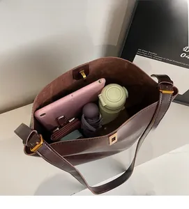 Top view of large brown leather tote bag interior showing ample storage for daily items