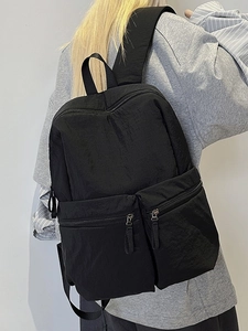 Minimalist black nylon travel backpack with large capacity and double front zip pockets