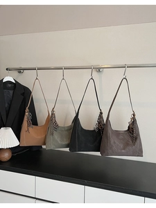Detailed display of four vintage hobo bags in khaki, green, black and brown matte leather