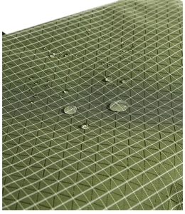 Close-up of water-resistant green checkered fabric with droplets on the surface