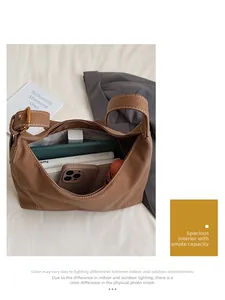 Detailed interior view showing large capacity storage for tablets and cosmetics in brown tote