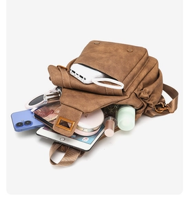 Macro view of retro brown leather bag interior showing large storage capacity for gadgets