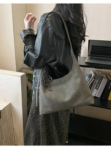 Detail of grey vintage hobo tote bag with Love charm and Fashion & Bags logo print