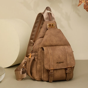 Detail showing the brown vintage crossbody bag with bronze hardware and JINGPIN logo