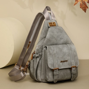 Detailed close-up of grey soft PU leather chest bag with bronze hardware and logo