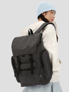 Chic checkered backpack with multi-pocket design and buckle closure for women's travel