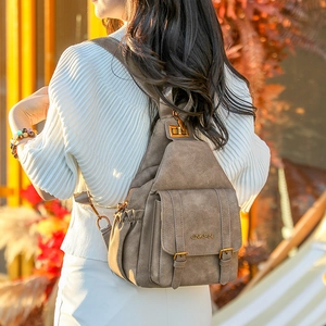 Close-up of vintage brown soft leather backpack with textured finish and metal hardware