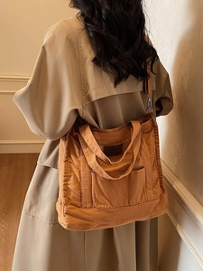 Minimalist ginger canvas tote bag with leather logo patch and adjustable strap for women
