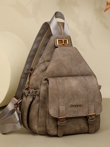 Retro brown soft leather backpack with wide strap and buckle closure in natural light