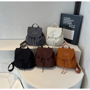 Detailed collection of five drawstring backpacks in black grey beige brown and caramel colors