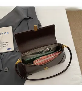 Interior view of the dark brown leather baguette bag showing phone and wallet storage