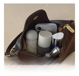 Detail showing high-capacity interior of vintage brown shoulder bag with zipper closure