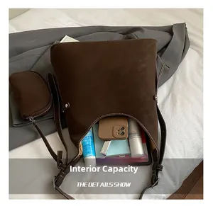 Detail of dark coffee bucket bag interior capacity with a matching small zipper pouch