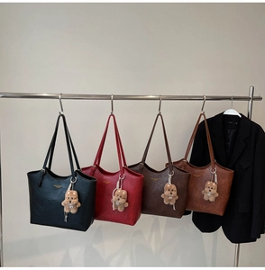 Detailed view of large vintage tote bags in four colors with plush bear charms
