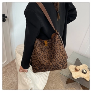 Fashionable brown leopard print tote bag featuring a golden lock shown from a side view