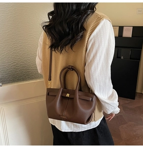 Brown litchi grain leather bucket bag with top handles and adjustable shoulder strap