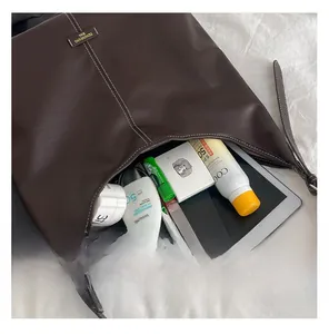 Deep brown leather tote interior showing spacious storage for tablet and daily cosmetics