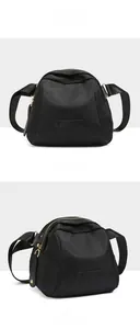 Vue détaillée du sac bandoulière en tissu oxford noir avec ferrures dorées et sangle