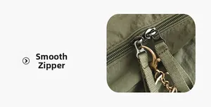 Detail view of smooth double metal zippers with olive green pull cords on outdoor backpack